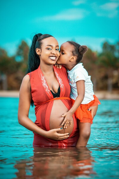 appy child and pregnant mom receiving gentle chiropractic care at Kissimmee Family Wellness Center