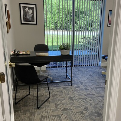 Consultation room at Kissimmee Family Wellness Center with Dr. Moore’s desk and nameplate.